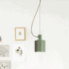 A single green pendant light hanging from a white ceiling. The light has a cylindrical shade and a long, thin cord.