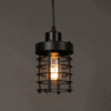 Ainaby Industrial Disk Cage Pendant Light - A black, industrial-style pendant light with a cage-like shade and an Edison-style filament bulb. The light is hanging from a black cord against a gray background.