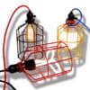ESBJÖRN Mini Cage Frame Pendant Light - Three colorful cage pendant lights with different shapes and sizes. The lights have red, yellow, and black cages and feature various types of light bulbs, including Edison bulbs and fluorescent bulbs.