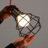 iron-mesh-ceiling-lamp-lighting-on-hands